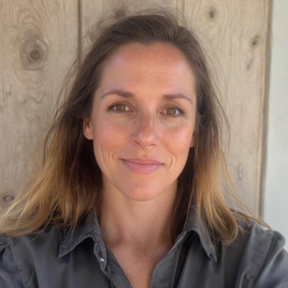 Portrait of Erin Jean against a soft wood background